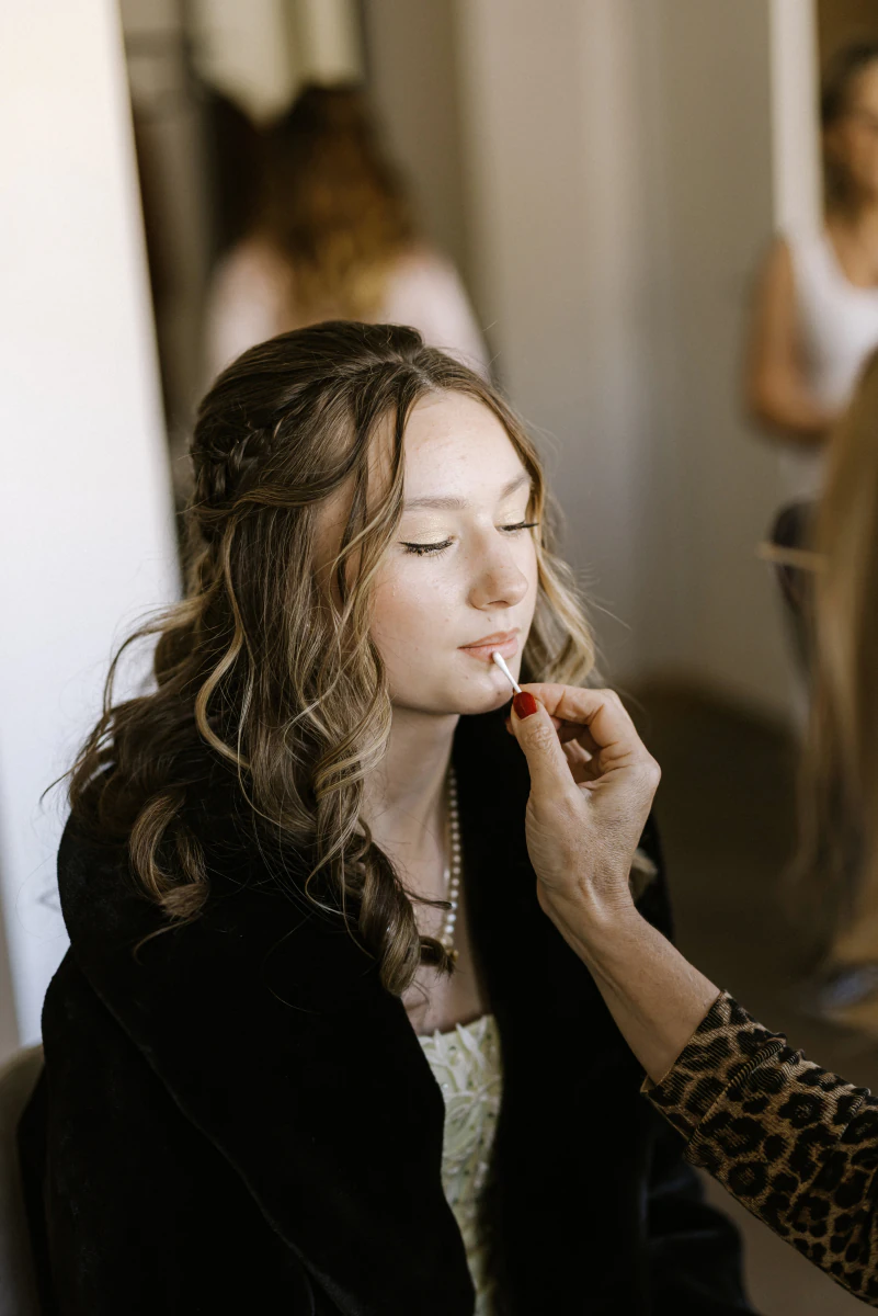 Lipstick being applied on the wedding morning