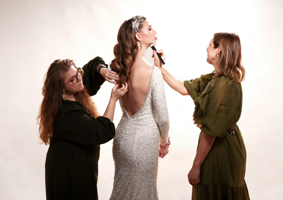 A team styling a model in the studio